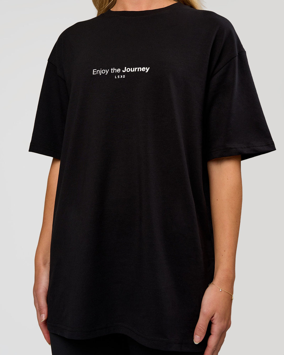 Woman wearing VS1 Enjoy The Journey FLXCotton Oversize Tee - Black | Model:Leandro | Size:XS - view 12