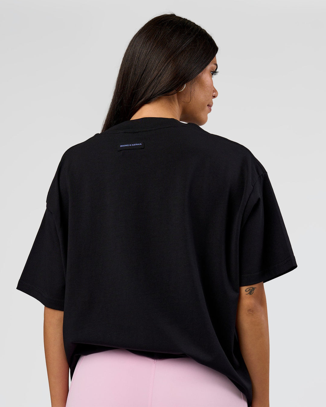 Woman wearing League Heavyweight FLXCotton Oversized Tee - Black-Power Cobalt | Model:Rhiley | Size:XS - view 15