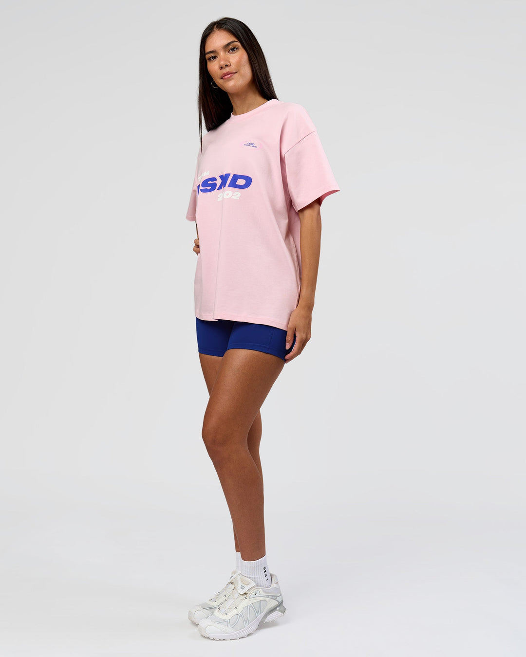 Woman wearing League Heavyweight FLXCotton Oversized Tee - Marshmallow-Power Cobalt | Model:Rhiley | Size:XS - view 9