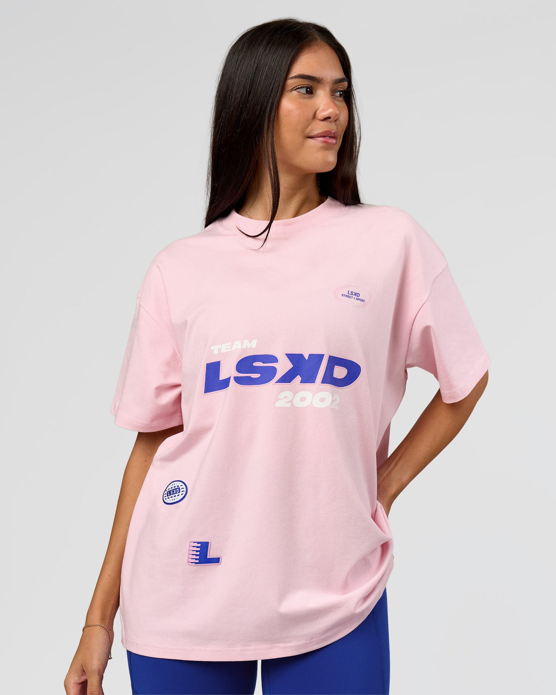 Woman wearing League Heavyweight FLXCotton Oversized Tee - Marshmallow-Power Cobalt | Model:Rhiley | Size:XS - view 11