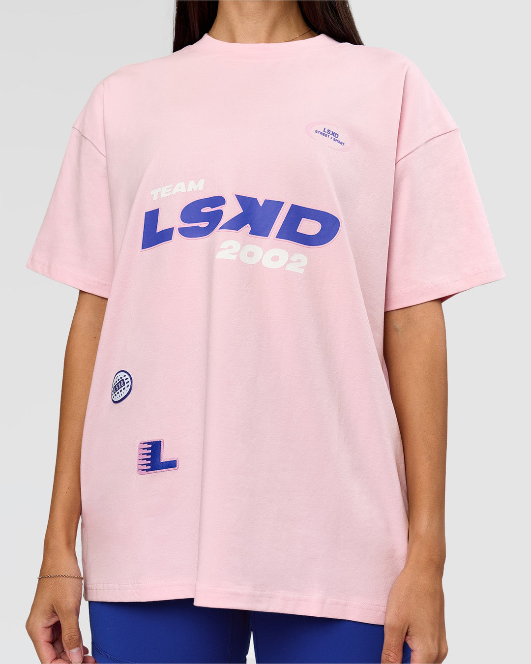 Woman wearing League Heavyweight FLXCotton Oversized Tee - Marshmallow-Power Cobalt | Model:Rhiley | Size:XS - view 14