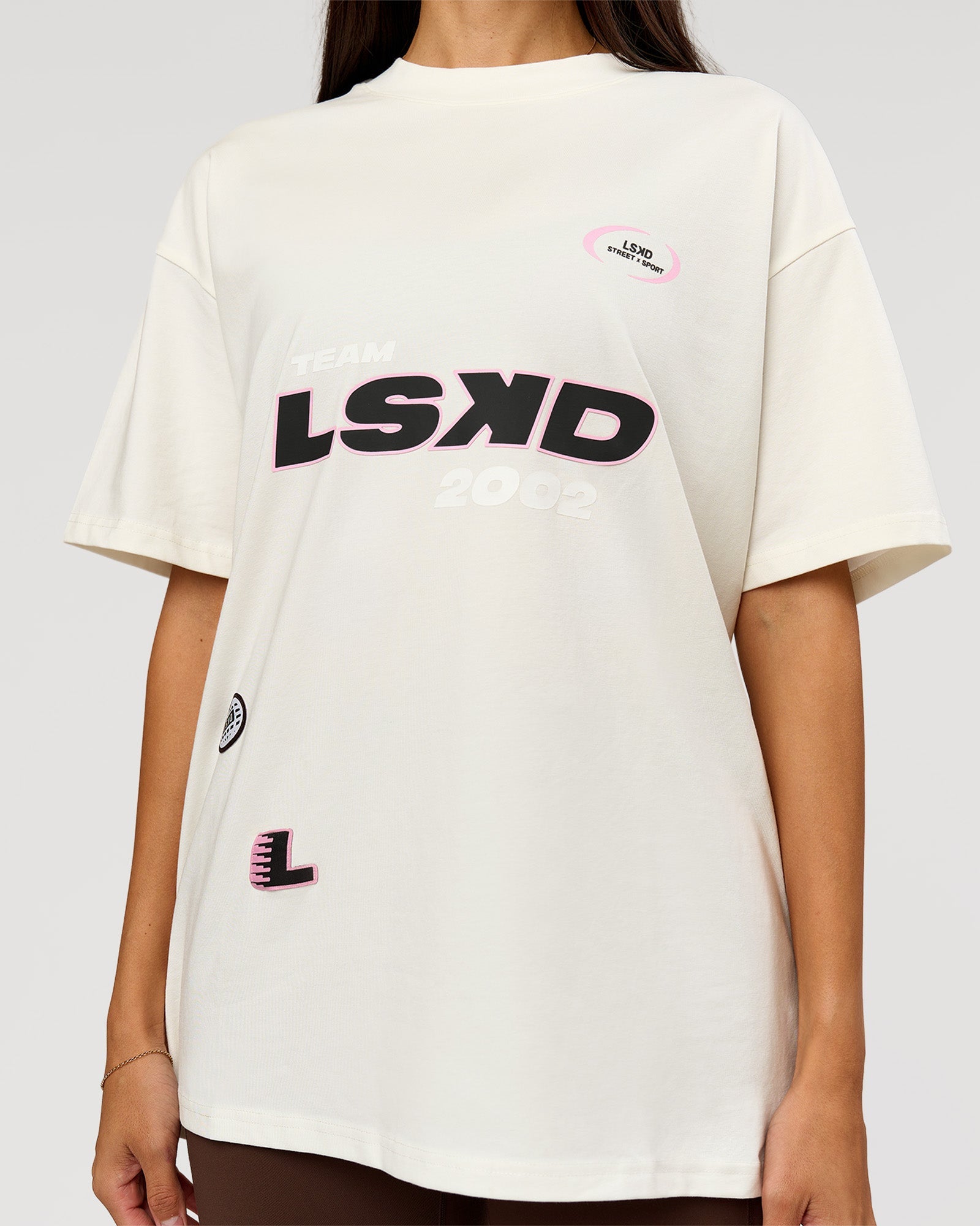 Woman wearing League Heavyweight FLXCotton Oversized Tee - Off White-Ground Coffee | Model:Rhiley | Size:XS