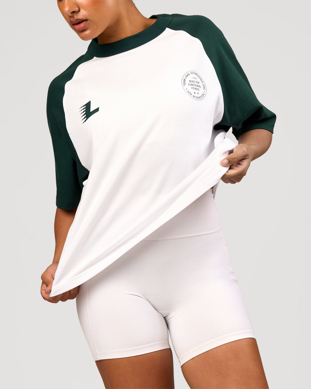 Woman wearing Victory Heavyweight Boxed Raglan Tee - White-Midnight Green | Model:Rosie | Size:XS - view 13