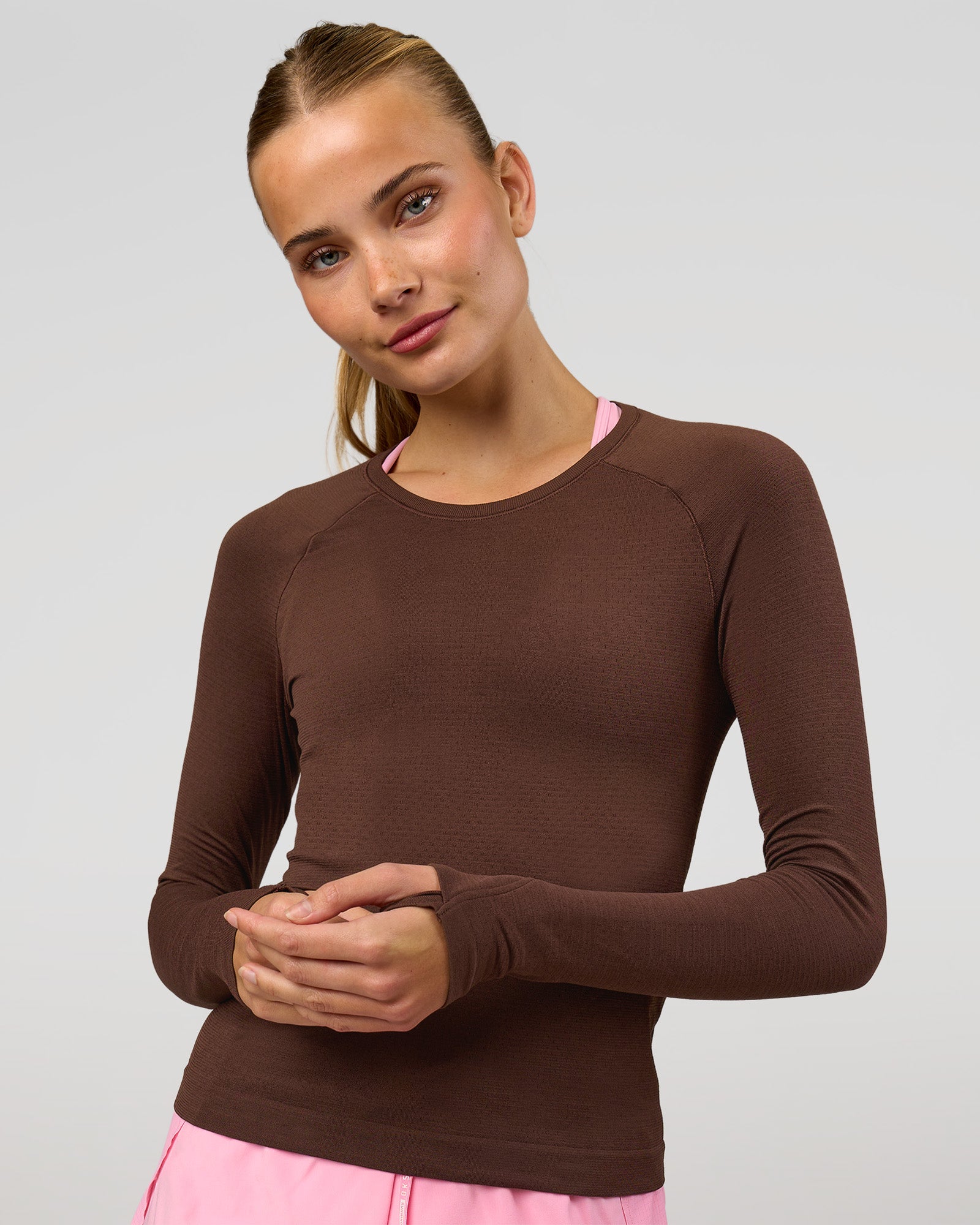 Woman wearing AeroFLX+ Seamless Long Sleeve Tee - Hot Chocolate/Hot Chocolate | Model:Taneisha | Size:XS