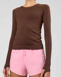 Woman wearing AeroFLX+ Seamless Long Sleeve Tee - Hot Chocolate/Hot Chocolate | Model:Taneisha | Size:XS | Thumbnail Index: 1