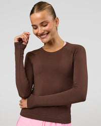 Woman wearing AeroFLX+ Seamless Long Sleeve Tee - Hot Chocolate/Hot Chocolate | Model:Taneisha | Size:XS | Thumbnail Index: 7