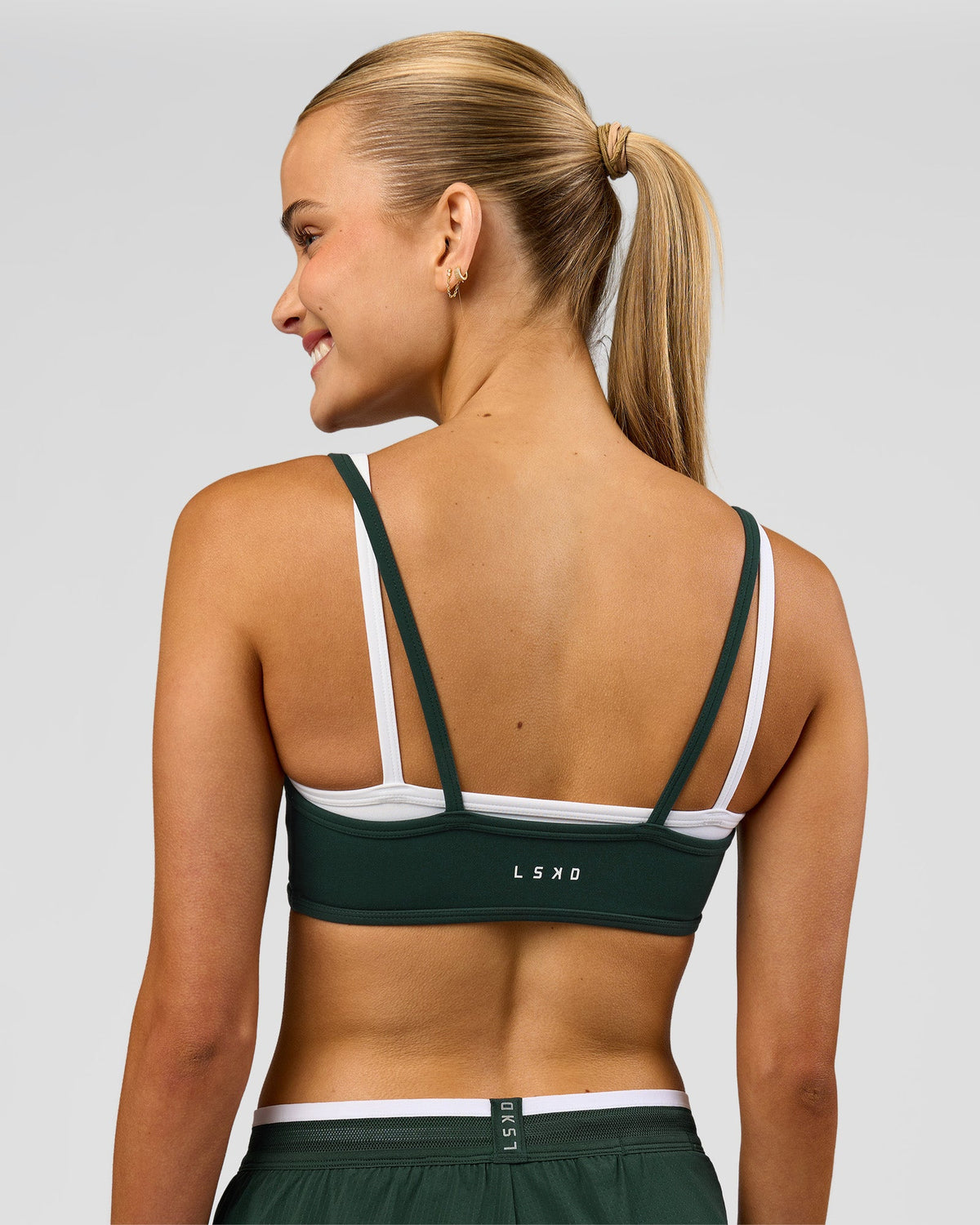 Woman wearing Balance Sports Bra - Midnight Green-White | Model:Taneisha | Size:XS