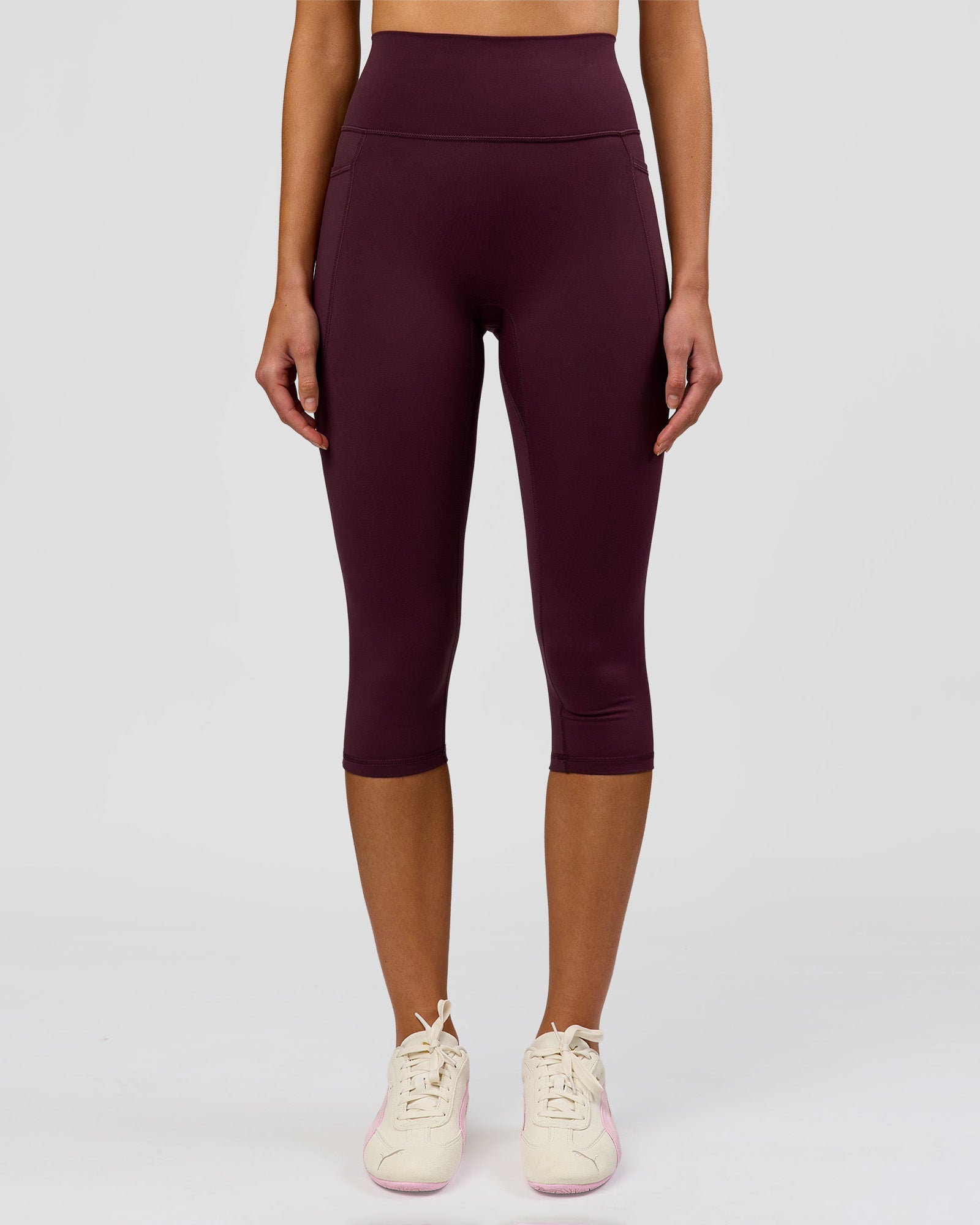 Woman wearing Fusion Ultra High-Rise 3/4 Legging Pockets - Cherry Lacquer | Model:Taneisha | Size:XS