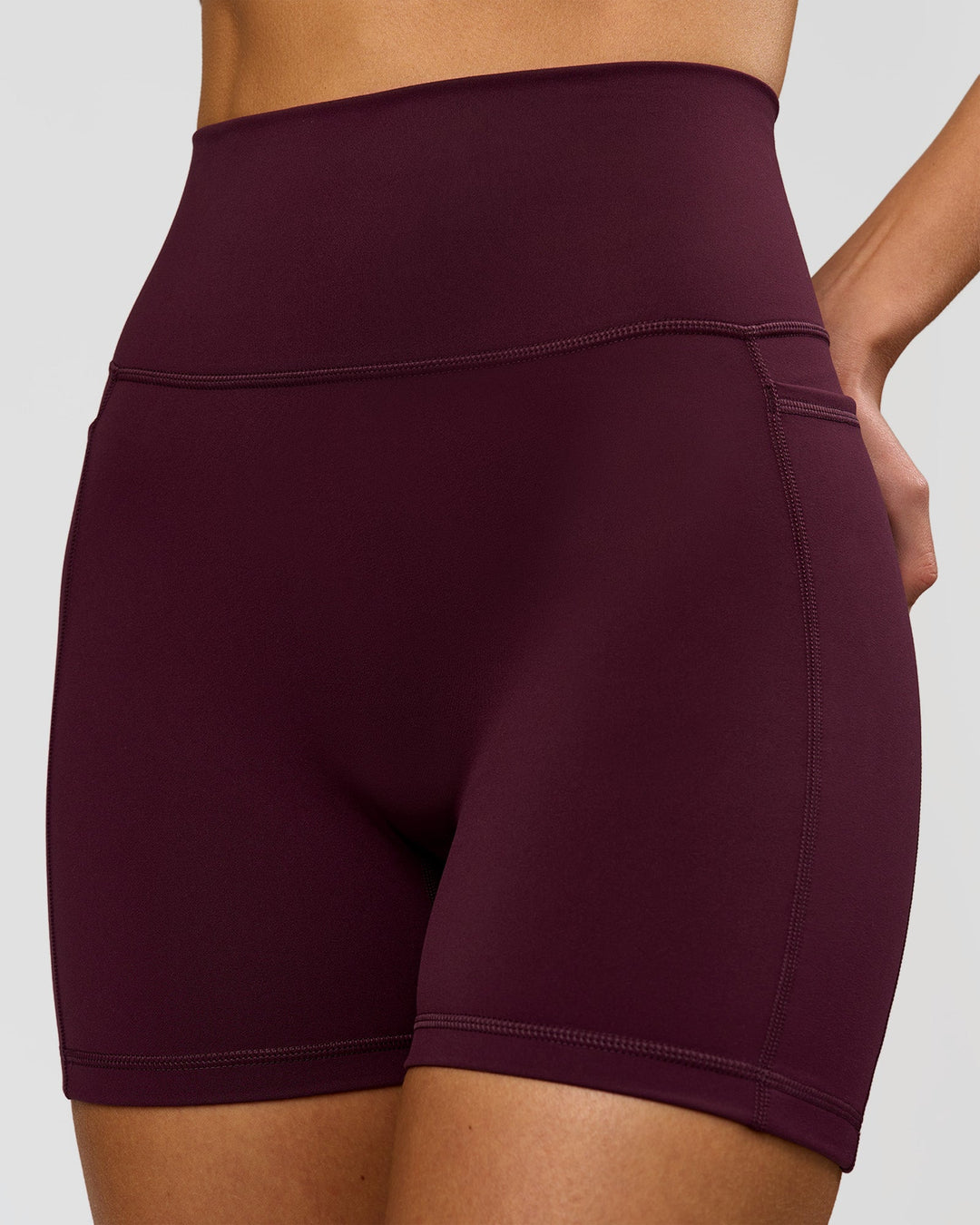 Woman wearing Fusion V-Contour Ultra High-Rise 4" Short Pockets - Cherry Lacquer | Model:Taneisha | Size:XS - view 2