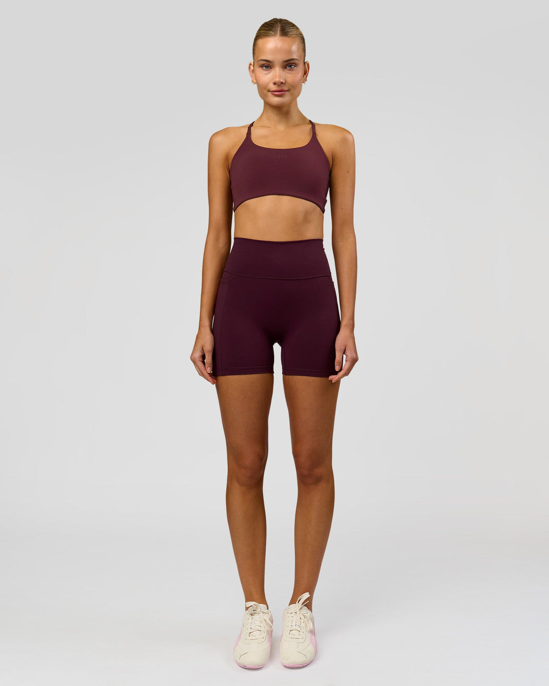 Woman wearing Fusion V-Contour Ultra High-Rise 4" Short Pockets - Cherry Lacquer | Model:Taneisha | Size:XS - view 3