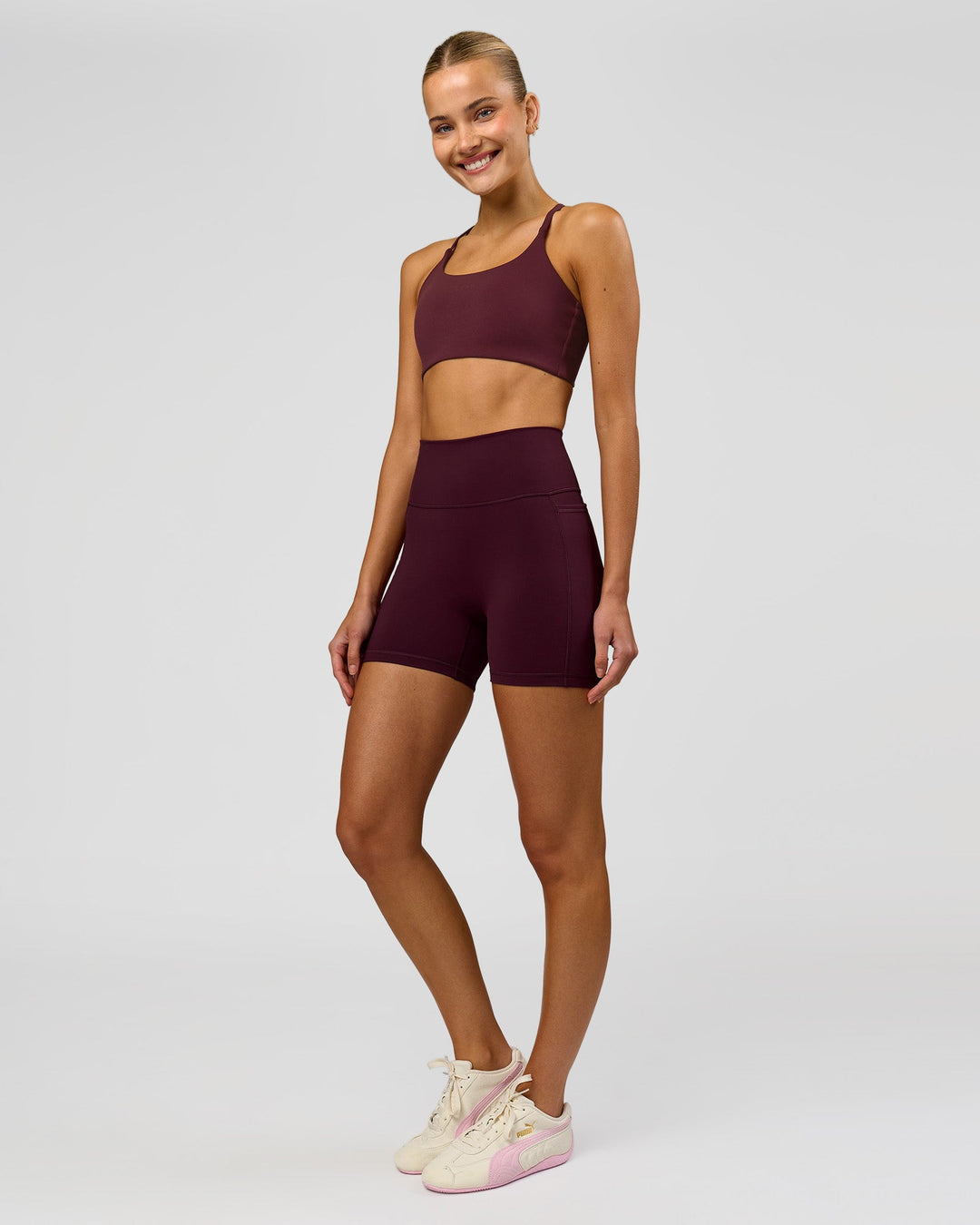 Woman wearing Fusion V-Contour Ultra High-Rise 4" Short Pockets - Cherry Lacquer | Model:Taneisha | Size:XS - view 6