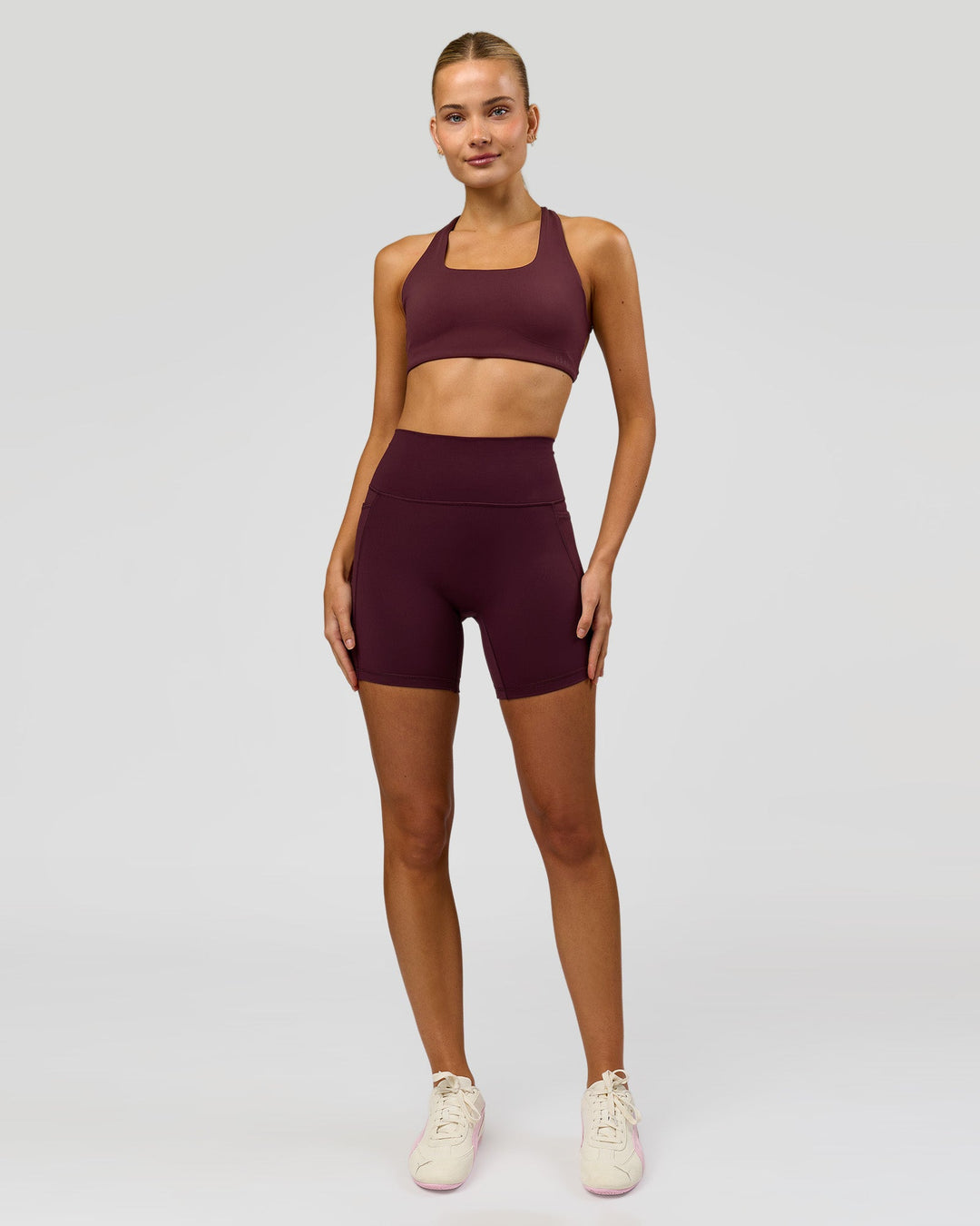 Woman wearing Fusion V-Contour Ultra High-Rise 6" Short Pockets - Cherry Lacquer | Model:Taneisha | Size:XS - view 3