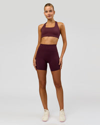 Woman wearing Fusion V-Contour Ultra High-Rise 6" Short Pockets - Cherry Lacquer | Model:Taneisha | Size:XS | Thumbnail Index: 2