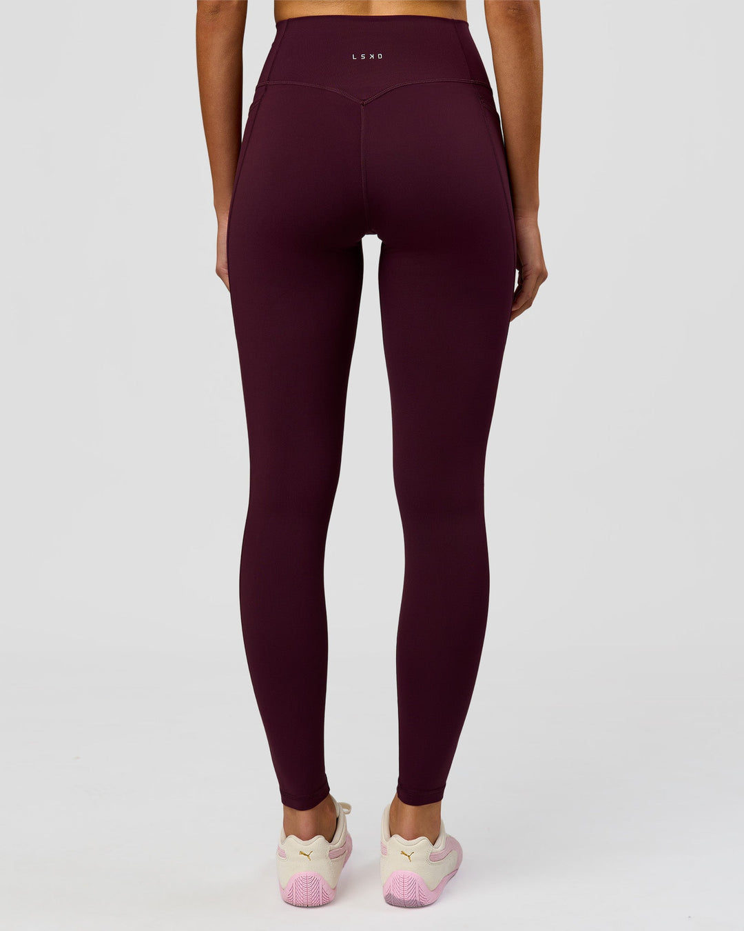 Woman wearing Fusion V-Contour Ultra High-Rise Full Length Legging Pockets - Cherry Lacquer | Model:Taneisha | Size:XS - view 1