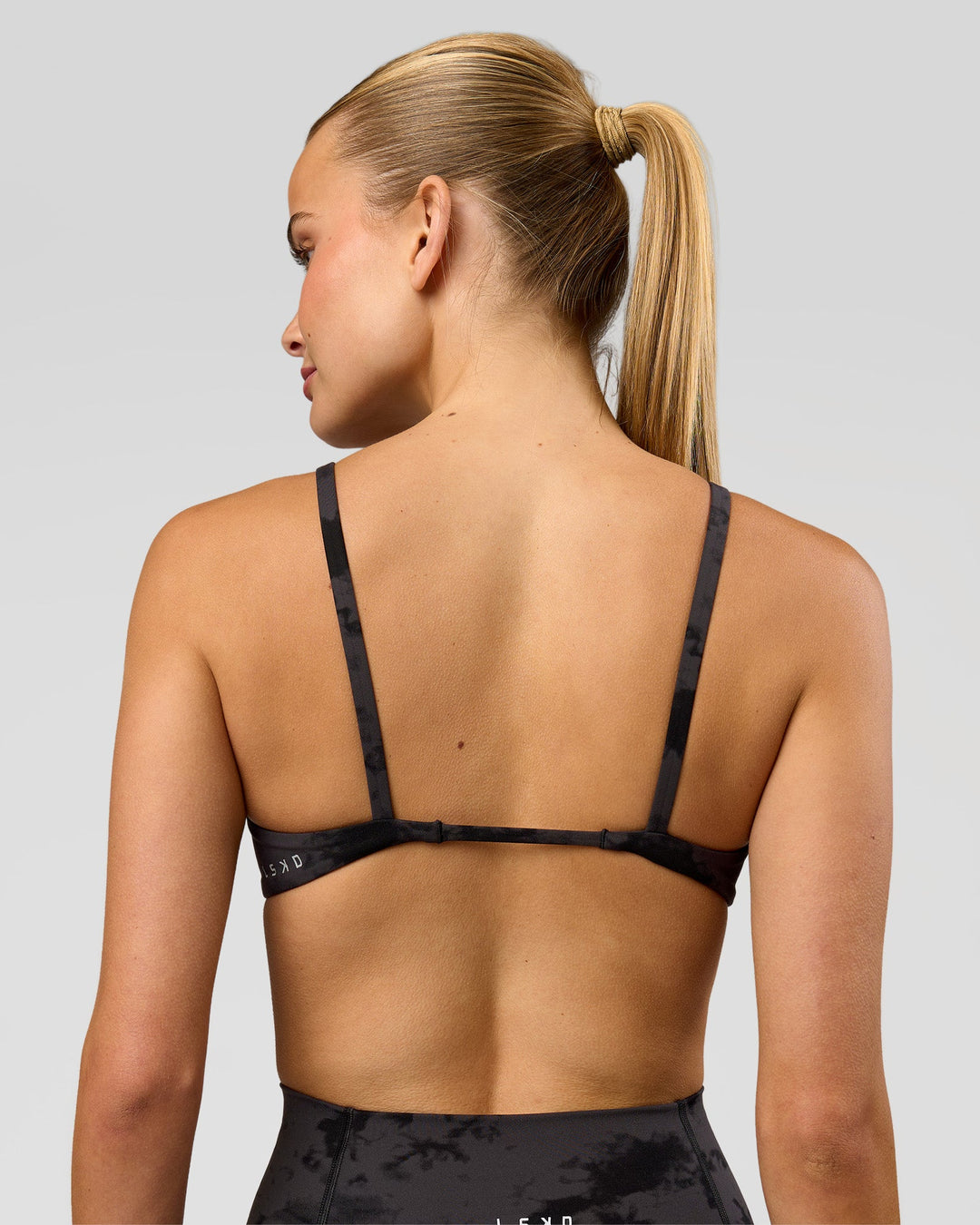 Woman wearing Minimal Sports Bra - Black Tie Dye | Model:Taneisha | Size:XS - view 2
