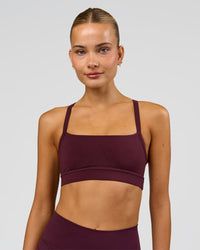 Woman wearing Momentum Sports Bra - Cherry Lacquer | Model:Taneisha | Size:XS | Thumbnail Index: 4
