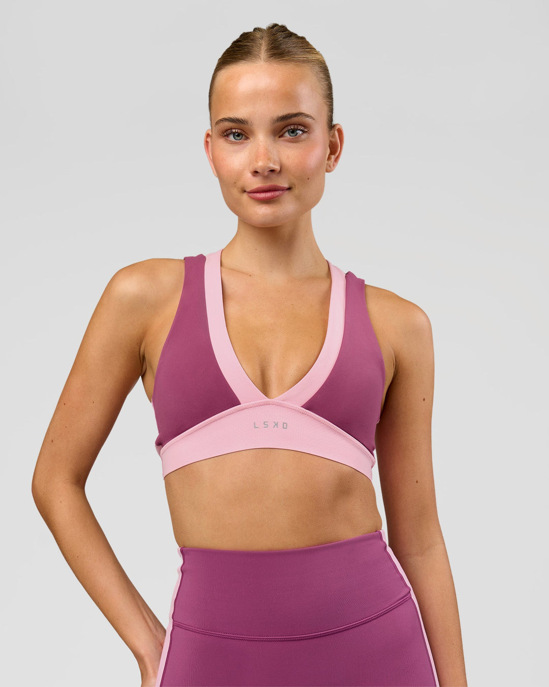 Woman wearing Stamina Layered Sports Bra - Boysenberry-Pink Rose | Model:Taneisha | Size:XS - view 4