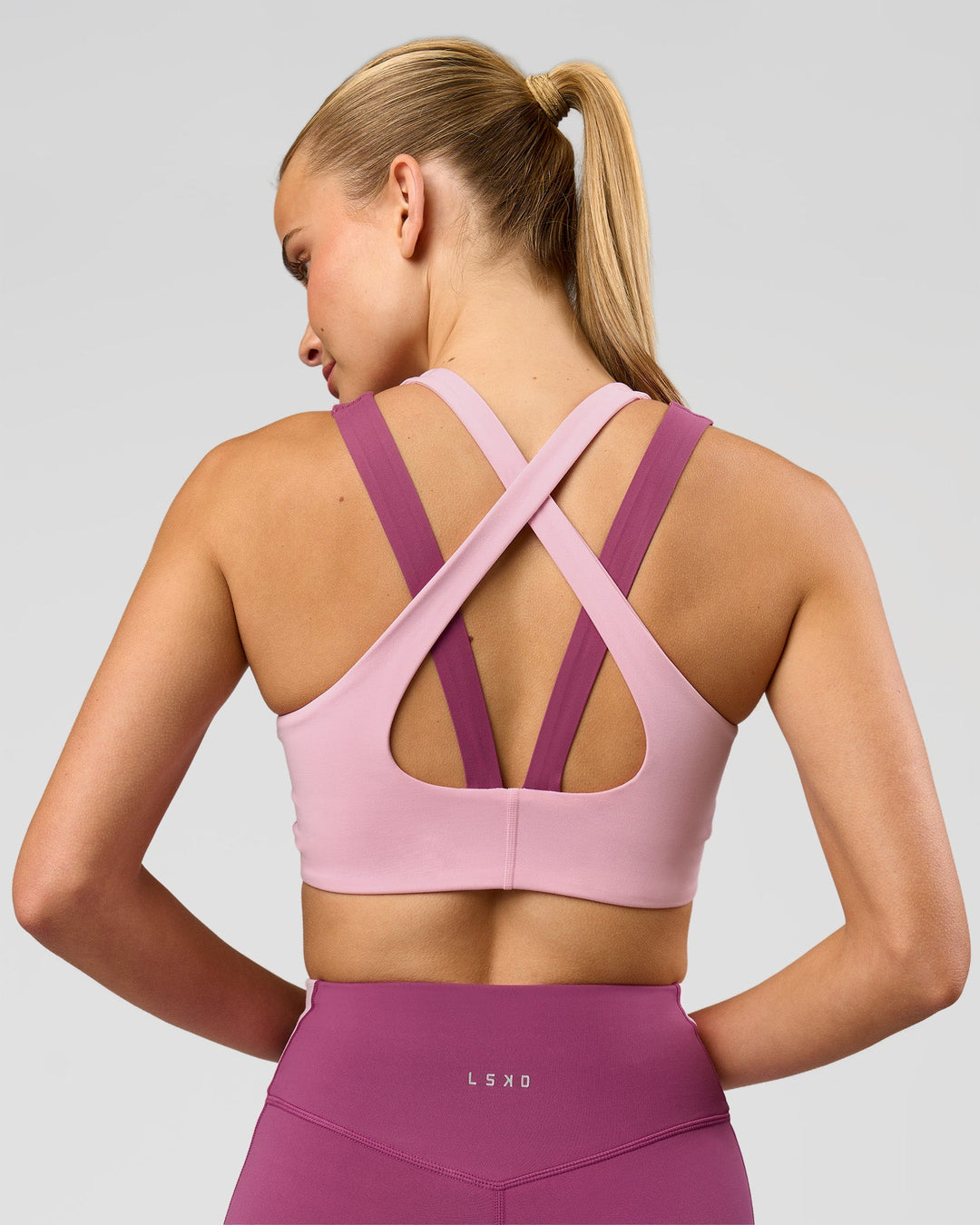 Woman wearing Stamina Layered Sports Bra - Boysenberry-Pink Rose | Model:Taneisha | Size:XS - view 1