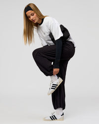 Woman wearing Stitch Up Track Pant - Black | Model:Taneisha | Size:XS | Thumbnail Index: 8