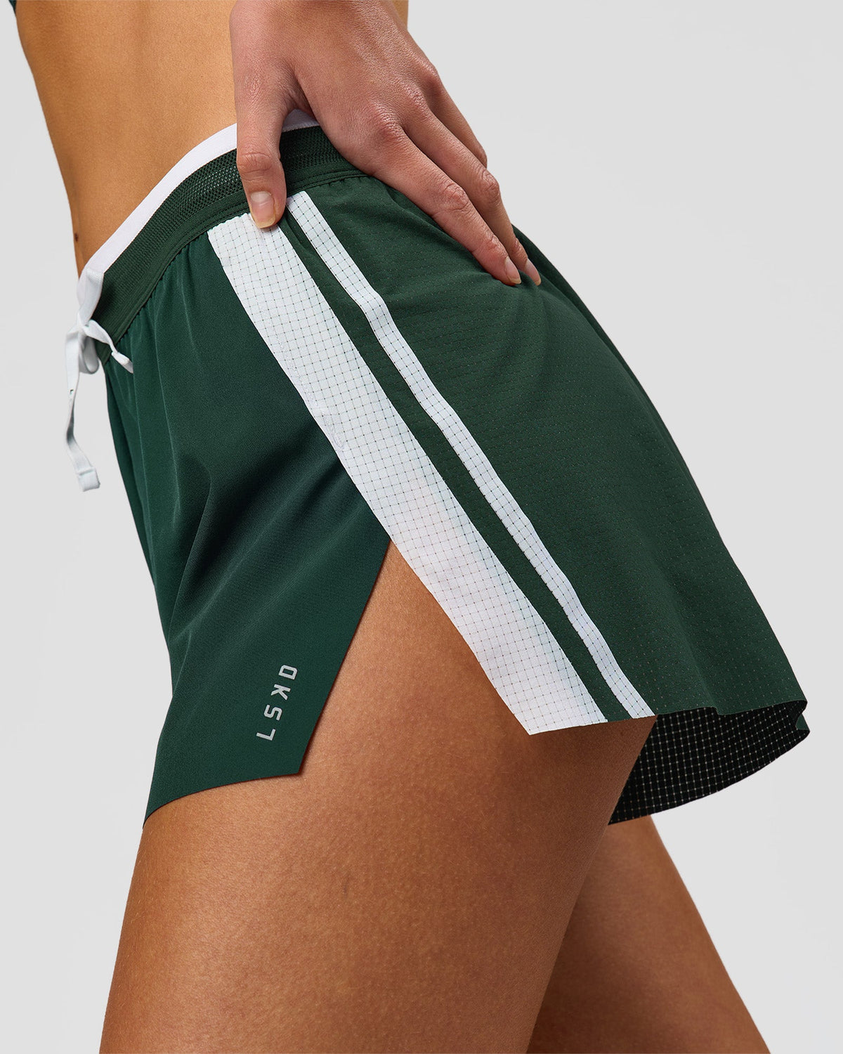 Woman wearing Trackline Accelerate 3" High-Rise Running Short - Midnight Green-White | Model:Taneisha | Size:XS