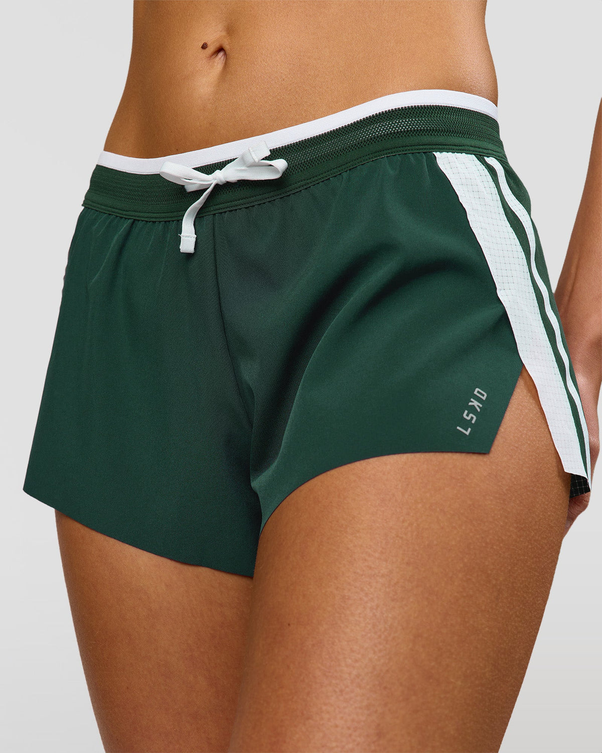 Woman wearing Trackline Accelerate 3" Mid Rise Running Short - Midnight Green-White | Model:Taneisha | Size:XS