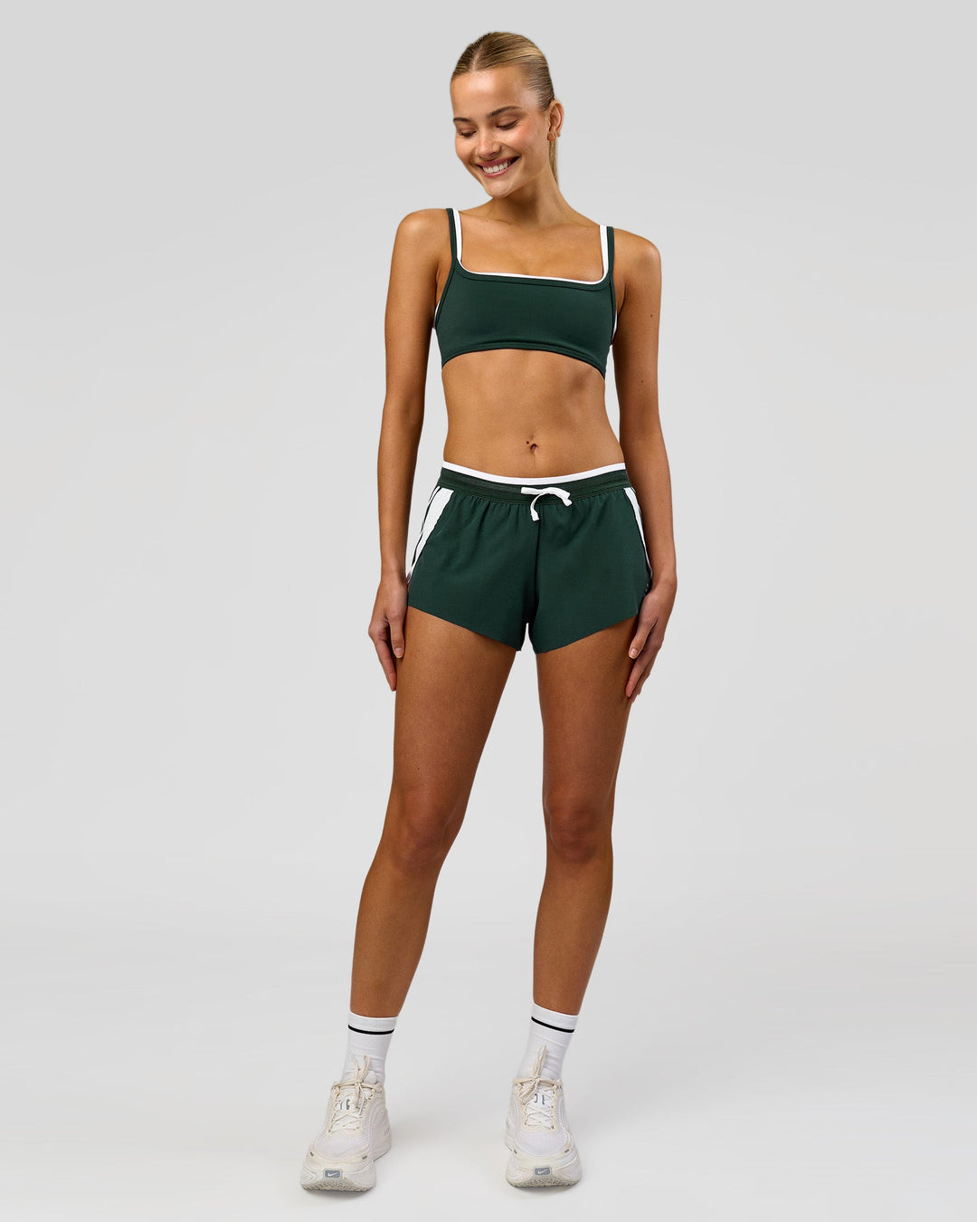 Woman wearing Trackline Accelerate 3" Mid Rise Running Short - Midnight Green-White | Model:Taneisha | Size:XS - view 4