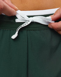 Woman wearing Trackline Accelerate 3" Mid Rise Running Short - Midnight Green-White | Model:Taneisha | Size:XS | Thumbnail Index: 5