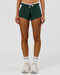 Woman wearing Trackline Accelerate 3" Mid Rise Running Short - Midnight Green-White | Model:Taneisha | Size:XS | Thumbnail Index: 8