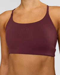 Woman wearing Twist Sports Bra - Cherry Lacquer | Model:Taneisha | Size:XS | Thumbnail Index: 0