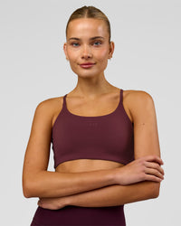 Woman wearing Twist Sports Bra - Cherry Lacquer | Model:Taneisha | Size:XS | Thumbnail Index: 3