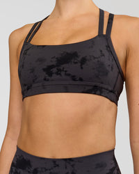 Woman wearing Velocity Sports Bra - Black Tie Dye | Model:Taneisha | Size:XS | Thumbnail Index: 1