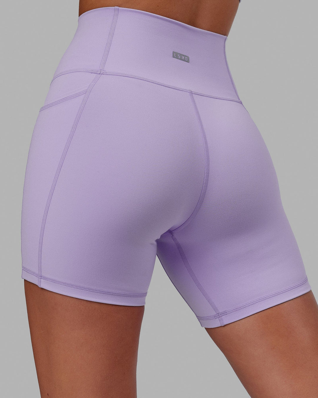 Woman wearing Fusion Ultra High-Rise 6" Short Pockets - Pale Lilac | Model:Milly | Size:S