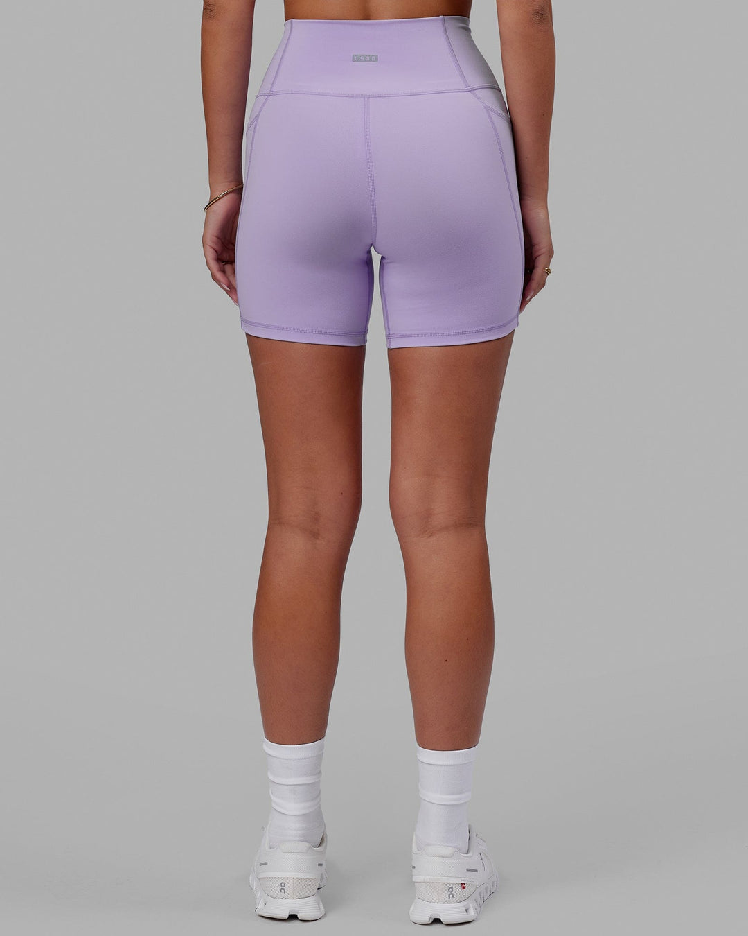 Woman wearing Fusion Ultra High-Rise 6" Short Pockets - Pale Lilac | Model:Milly | Size:S