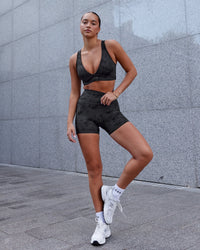 Woman wearing Fusion Ultra High-Rise 4" Short Pockets - Black Tie-Dye | Model:Milly | Size:S