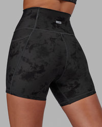 Woman wearing Fusion Ultra High-Rise 4" Short Pockets - Black Tie-Dye | Model:Milly | Size:S