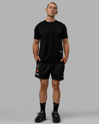 Man wearing Millennium 7" Shorts - Black