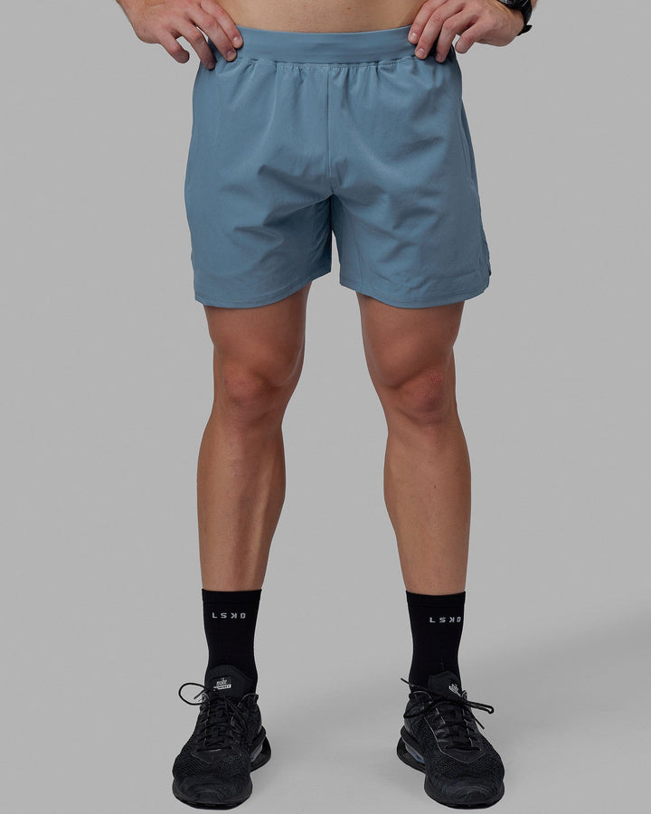 Man wearing Challenger 6&quot; Lined Performance Shorts - Elemental Blue
