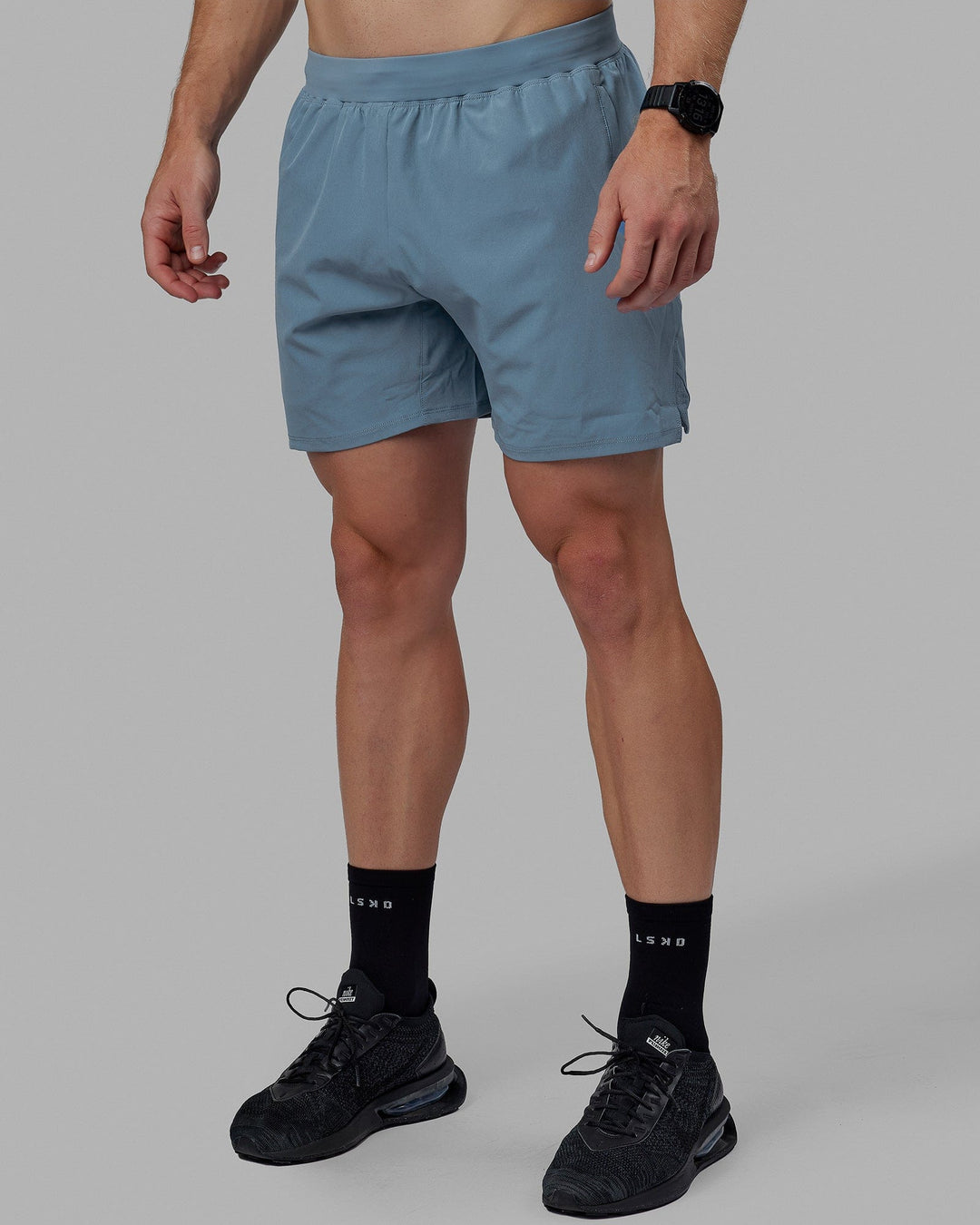 Man wearing Challenger 6" Lined Performance Shorts - Elemental Blue