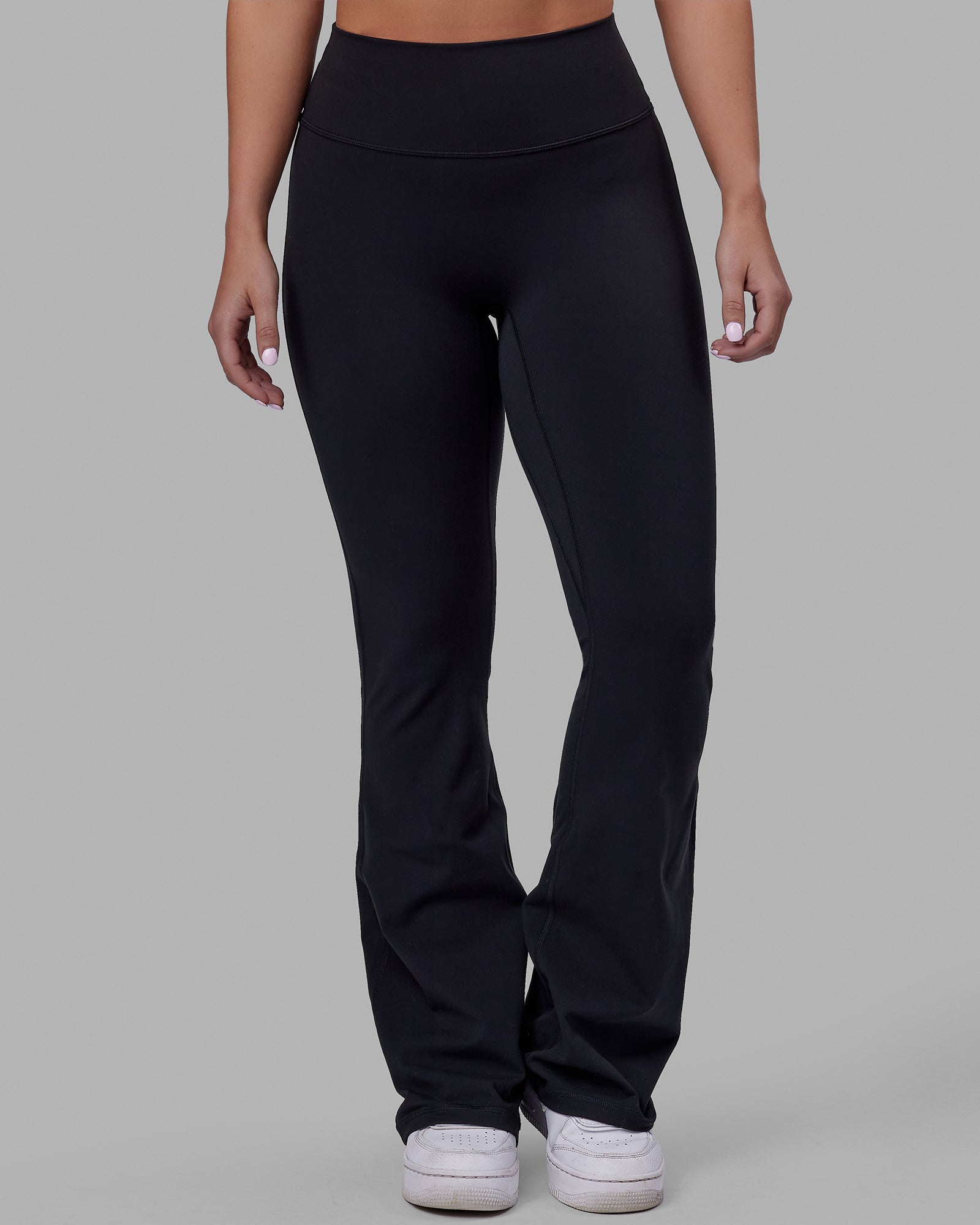 Woman wearing Fusion Ultra High-Rise Flared Petite Legging - Black| Model:Gracie | Size:S