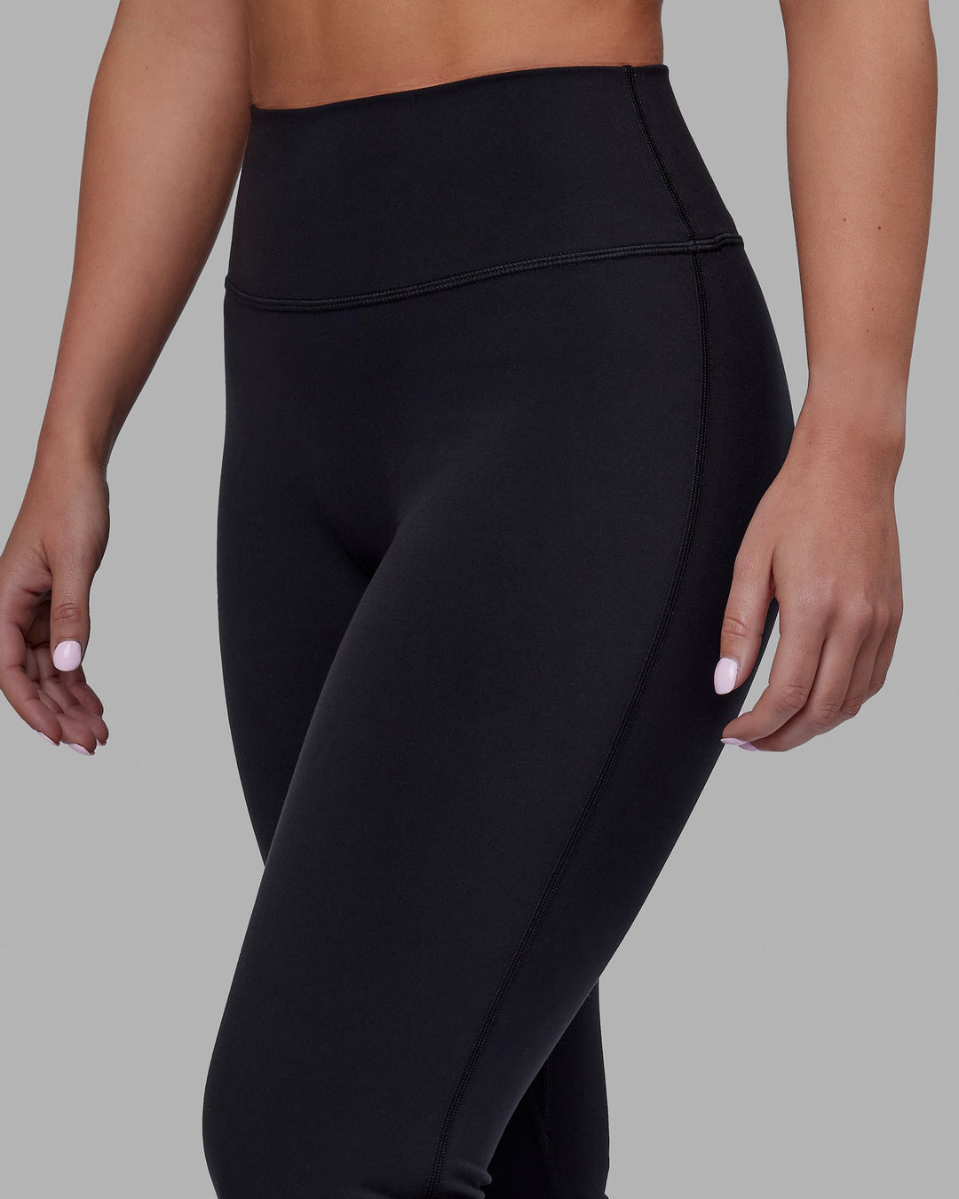Woman wearing Fusion Ultra High-Rise Flared Petite Legging - Black| Model:Gracie | Size:S