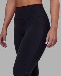 Woman wearing Fusion Ultra High-Rise Flared Petite Legging - Black| Model:Gracie | Size:S