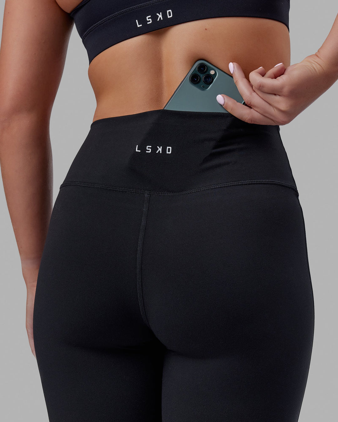 Woman wearing Fusion Ultra High-Rise Flared Petite Legging - Black| Model:Gracie | Size:S
