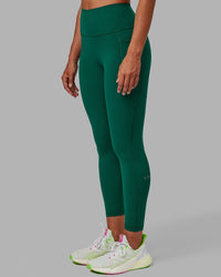 Woman wearing Fusion Ultra High-Rise 7/8 Legging Pockets - Malachite | Model:Sophie | Size:S