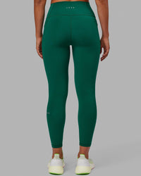 Woman wearing Fusion Ultra High-Rise 7/8 Legging Pockets - Malachite | Model:Sophie | Size:S