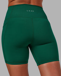 Woman wearing Fusion Ultra High-Rise 6" Short Pockets - Malachite | Model:Sophie | Size:S