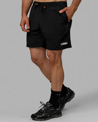 Man wearing Millennium 7" Shorts - Black