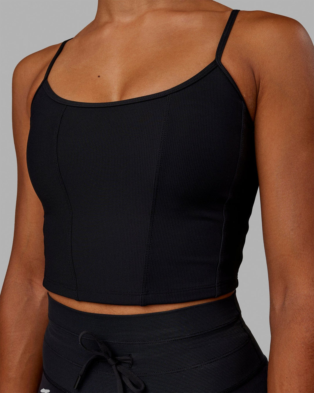 Woman wearing Resistance Ribbed Shelf Bra Performance Tank - Black