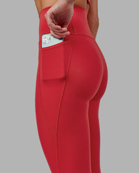 Woman wearing Fusion Ultra High-Rise 7/8 Legging Pockets - Scarlet | Model:Elise | Size:S
